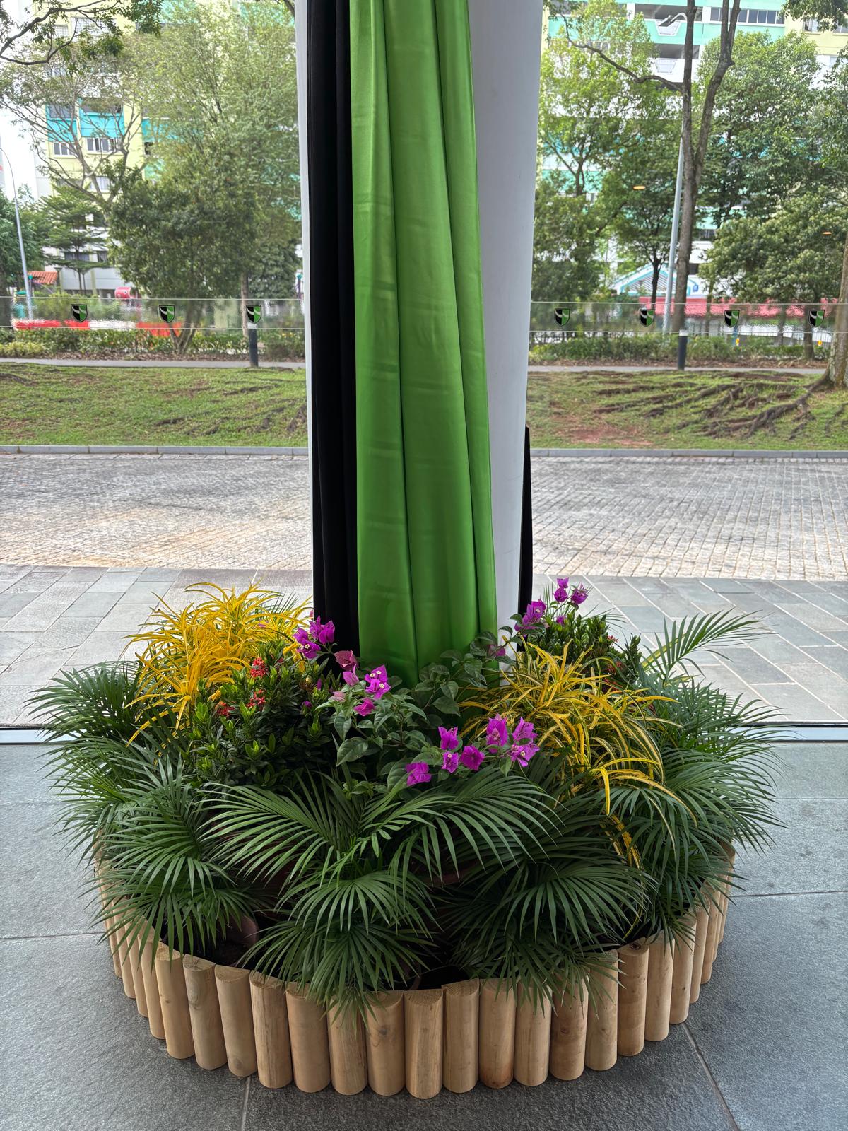 Round bamboo log planter with tropical flowers