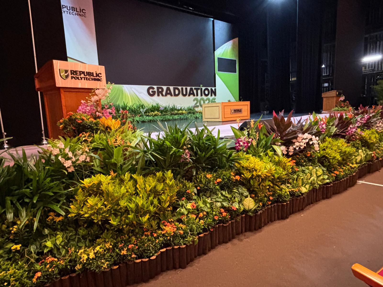 Polytechnic graduation stage with tropical floral installation