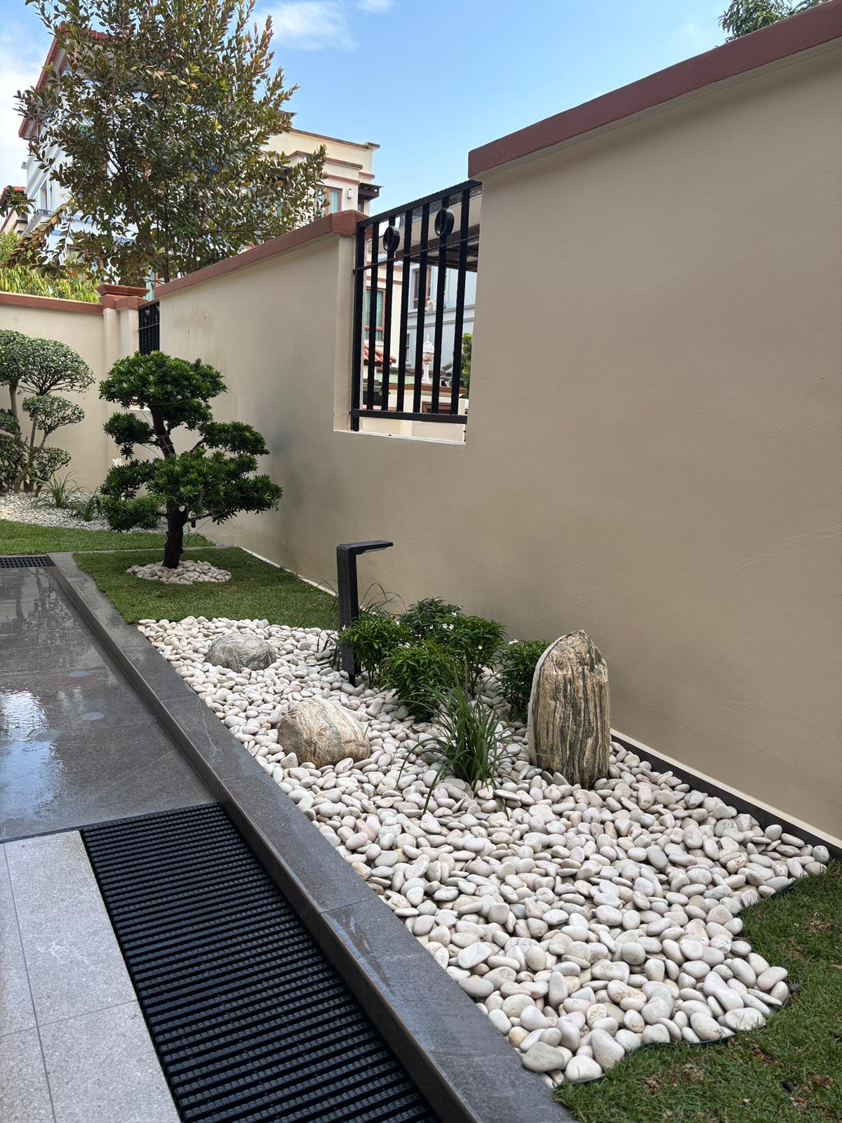 Pebble garden with sculptural rocks and bonsai